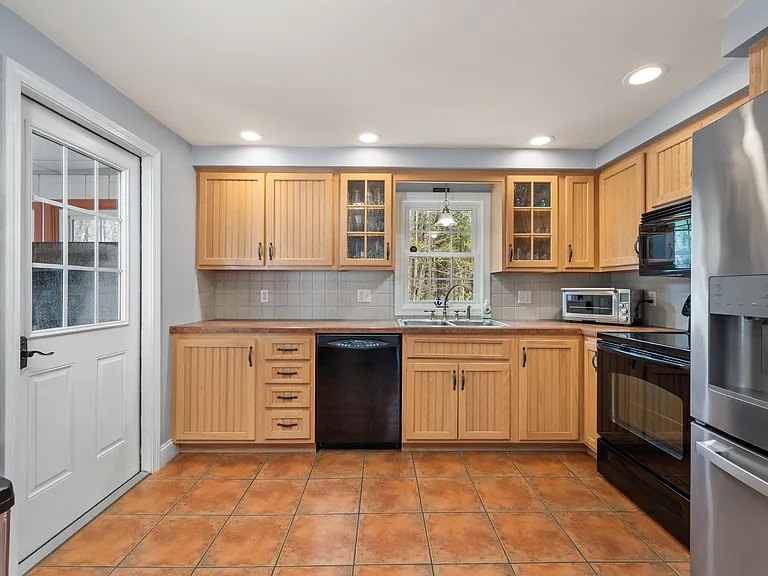 Kitchen with wood cabinets at The Brookhurst Lake House
